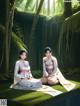 A couple of women sitting on top of a lush green field.