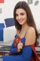 A woman in a superman costume posing for a picture.