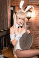 A woman in a bunny costume sitting on a table.