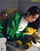 A woman laying on a bed reading a book with a teddy bear.