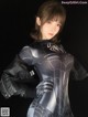 A woman in a black and silver spider suit posing for a picture.